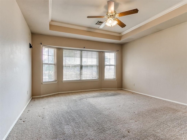 unfurnished room with a tray ceiling, crown molding, carpet flooring, and ceiling fan