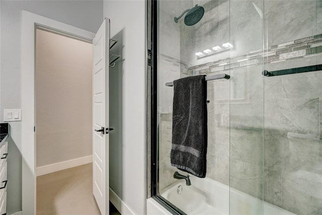 bathroom with shower / bath combination with glass door, tile patterned flooring, and vanity