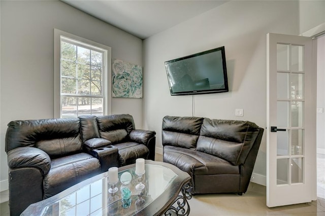 living room featuring light tile patterned floors and french doors