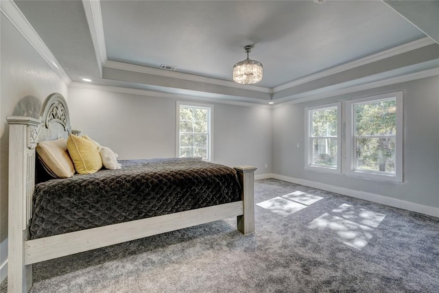 bedroom featuring carpet floors, a tray ceiling, and crown molding