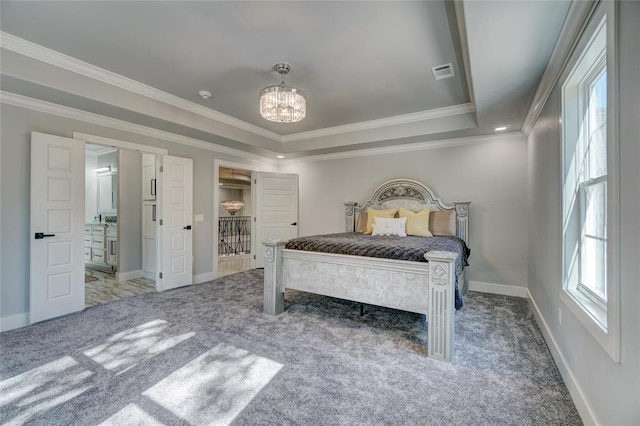 carpeted bedroom with a raised ceiling, ornamental molding, and a chandelier