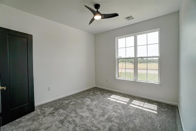 empty room with ceiling fan and light carpet