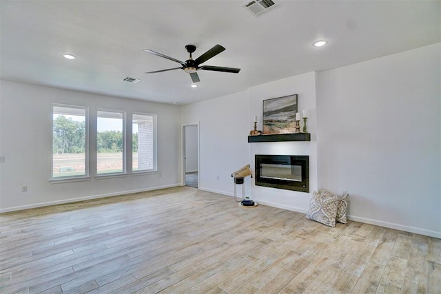 unfurnished living room with ceiling fan and light wood-type flooring