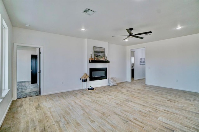 unfurnished living room with ceiling fan and light wood-type flooring