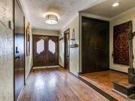 doorway featuring wood-type flooring and crown molding