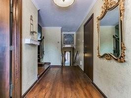 corridor with dark hardwood / wood-style flooring