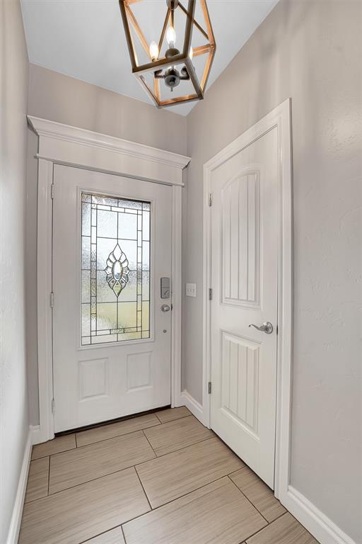 foyer with an inviting chandelier