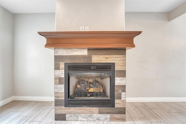 room details with hardwood / wood-style floors and a tile fireplace