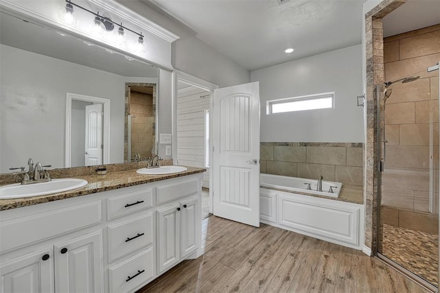 bathroom featuring vanity, shower with separate bathtub, and hardwood / wood-style flooring