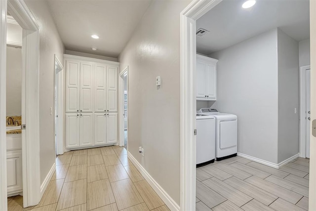 interior space with cabinets and washing machine and dryer