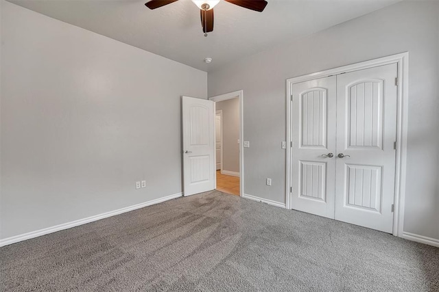 unfurnished bedroom with ceiling fan, light carpet, and a closet