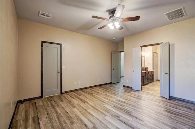 unfurnished bedroom with connected bathroom, ceiling fan, and light hardwood / wood-style floors