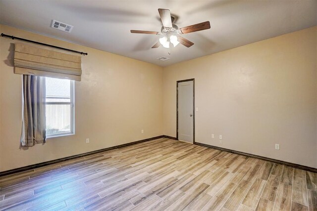 spare room featuring ceiling fan and light hardwood / wood-style floors