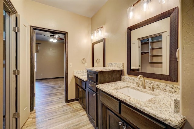 bathroom featuring ceiling fan, vanity, and hardwood / wood-style flooring