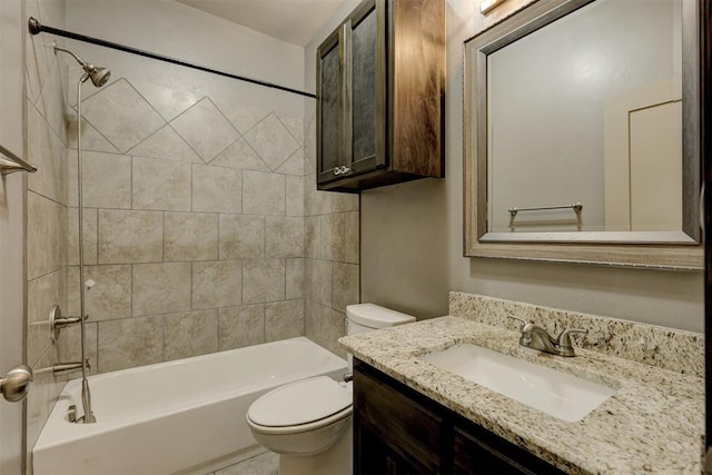 full bathroom with toilet, vanity, and tiled shower / bath