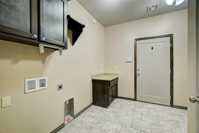 clothes washing area featuring washer hookup, electric dryer hookup, and cabinets