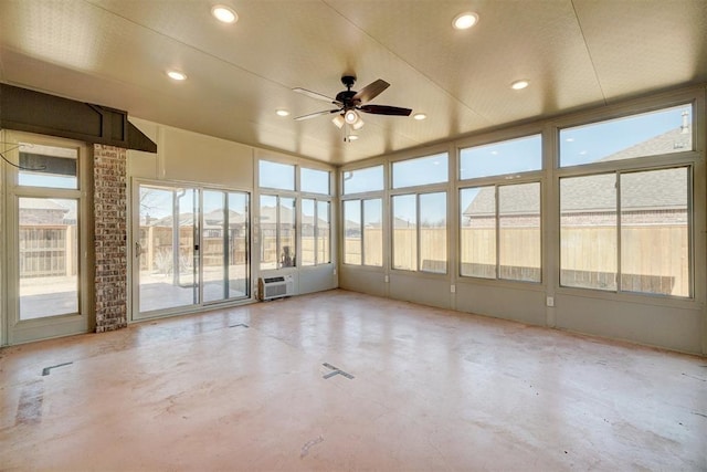 unfurnished sunroom with ceiling fan