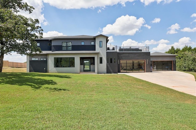 view of front of property with a front lawn, a garage, and solar panels