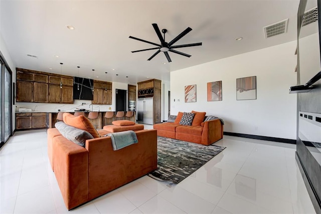 living room with ceiling fan and light tile patterned flooring