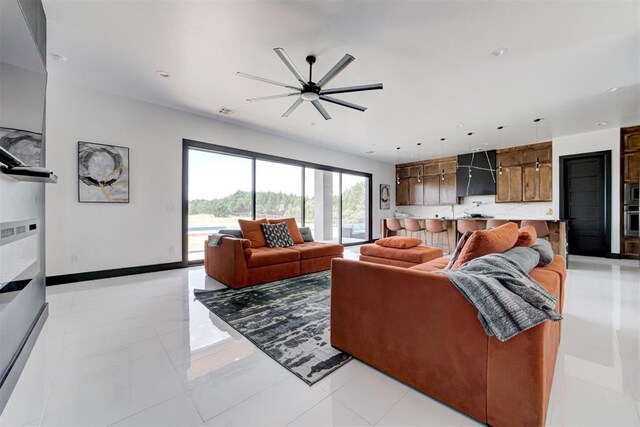 tiled living room featuring ceiling fan