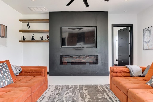 living room featuring a fireplace and ceiling fan