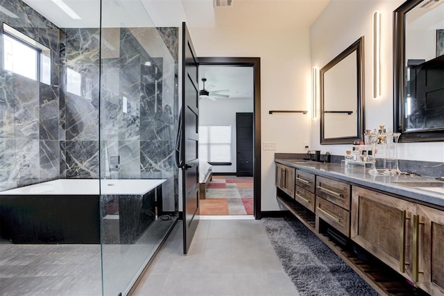 bathroom with a bath, ceiling fan, vanity, and a healthy amount of sunlight