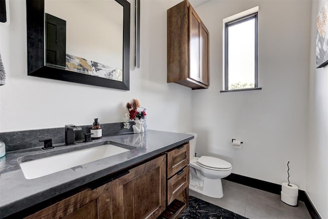 bathroom with tile patterned flooring, vanity, and toilet