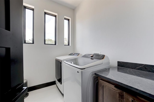 washroom with cabinets and independent washer and dryer