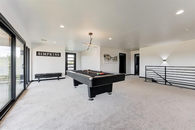 recreation room with a notable chandelier, light colored carpet, and billiards