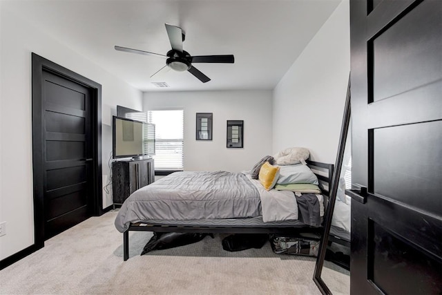 bedroom with ceiling fan and light carpet