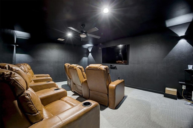 carpeted cinema room with ceiling fan