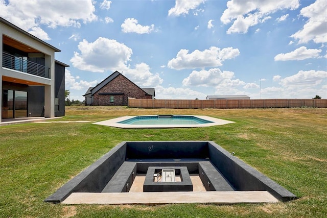 view of swimming pool featuring a fire pit and a lawn