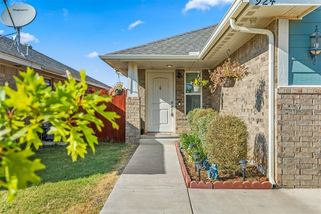 doorway to property with brick siding