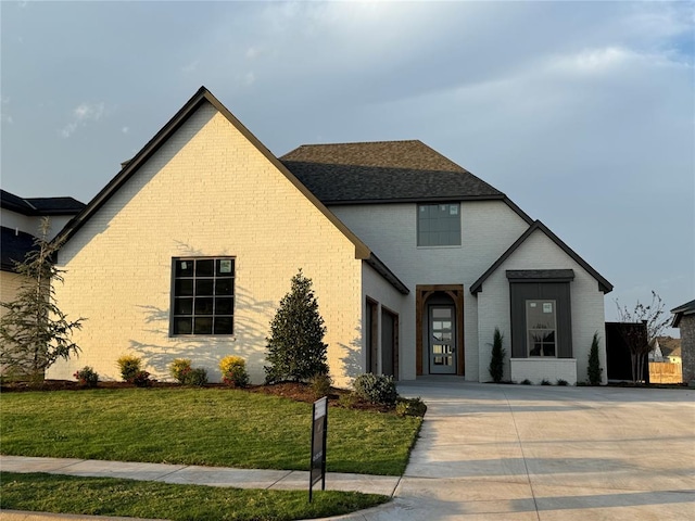 view of front of house with a garage and a front lawn