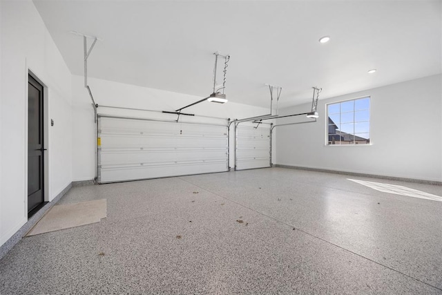 garage featuring recessed lighting, a garage door opener, and baseboards