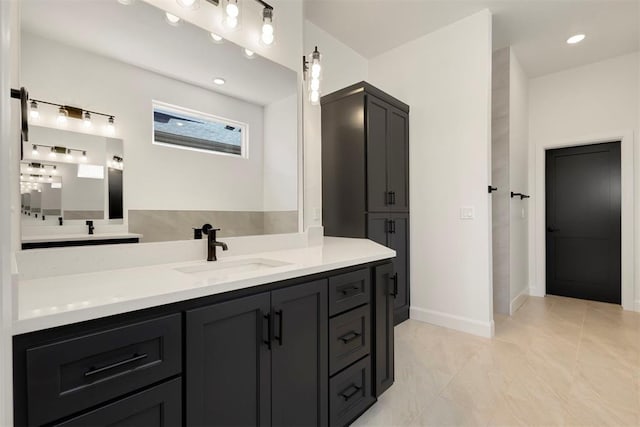 full bathroom with recessed lighting, vanity, and baseboards