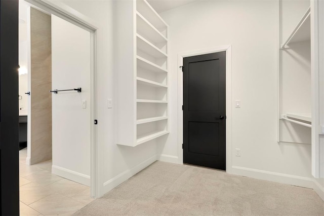 spacious closet featuring light carpet