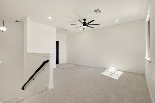 empty room featuring light carpet, visible vents, and recessed lighting