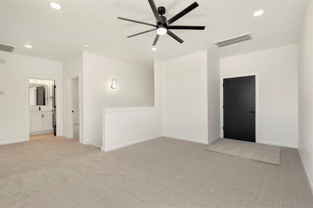 spare room with recessed lighting, visible vents, baseboards, and light colored carpet