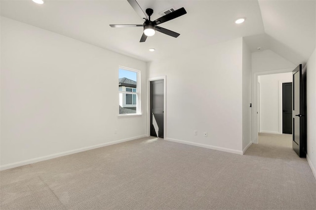 unfurnished bedroom with recessed lighting, light colored carpet, lofted ceiling, and baseboards