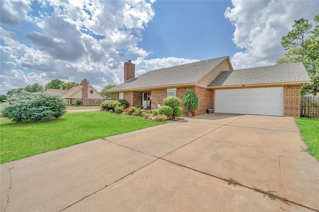 view of front of property with a front yard and a garage