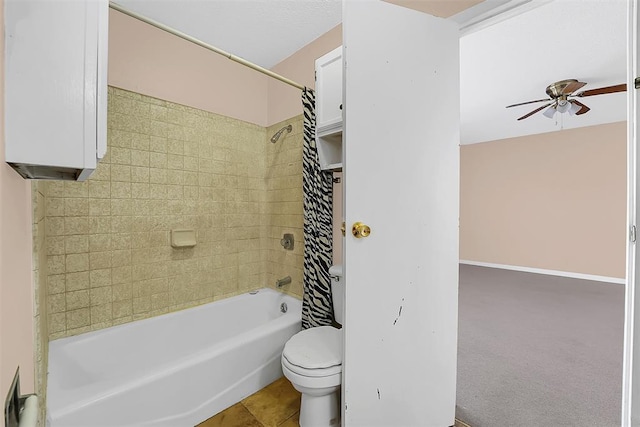 bathroom with toilet, tile patterned floors, shower / tub combo with curtain, and ceiling fan