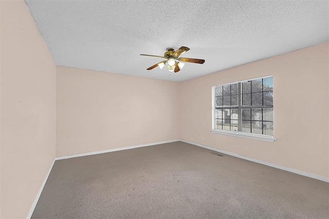 carpeted empty room featuring a textured ceiling and ceiling fan