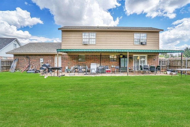 rear view of house with a lawn, cooling unit, and a patio