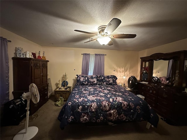 carpeted bedroom featuring ceiling fan and a textured ceiling