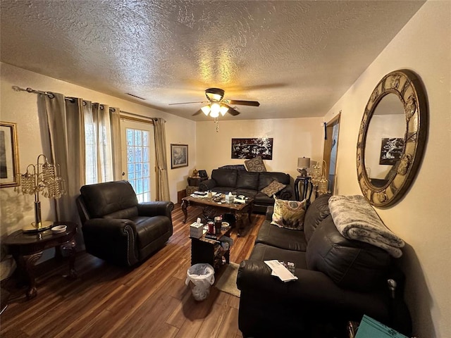 living room with hardwood / wood-style floors, ceiling fan, and a textured ceiling