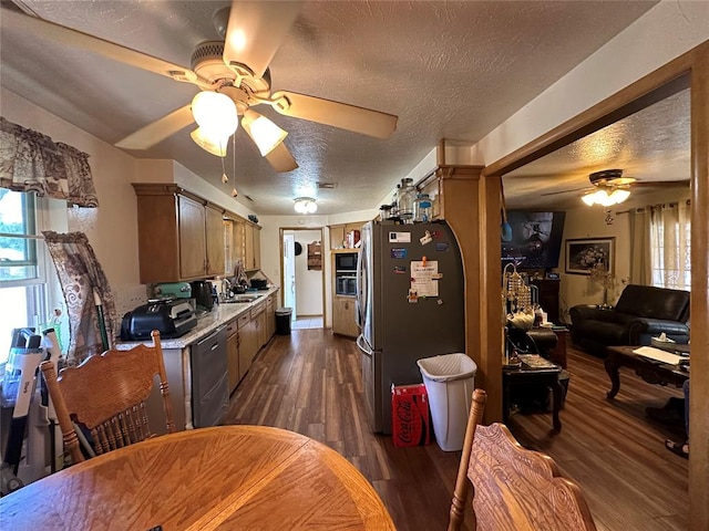 kitchen with stainless steel fridge, a textured ceiling, sink, dishwasher, and dark hardwood / wood-style floors