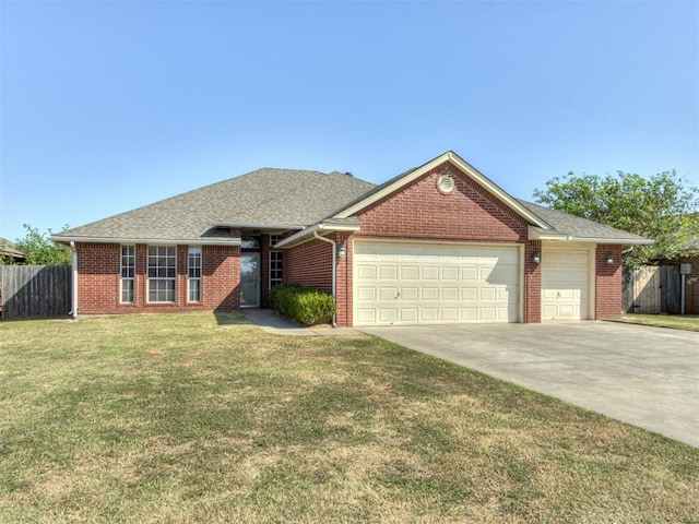 ranch-style home with a garage and a front lawn