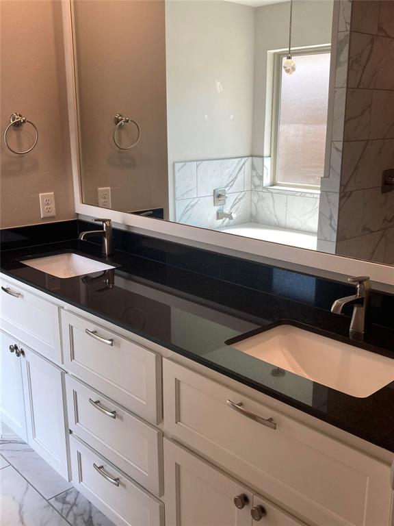 bathroom featuring vanity and a washtub