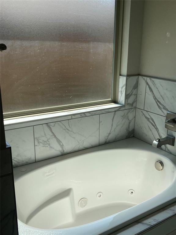 bathroom featuring a tub to relax in